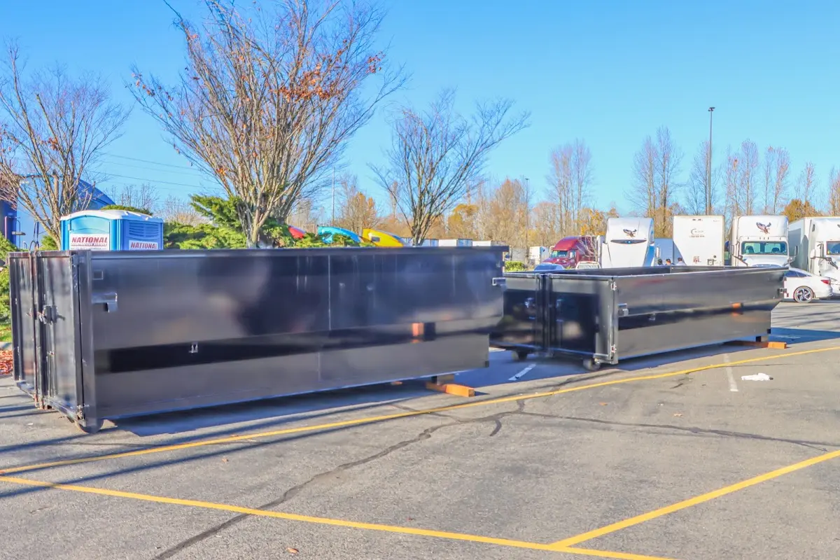 Professional dumpster rental service with roll-off container on residential driveway in Mineola